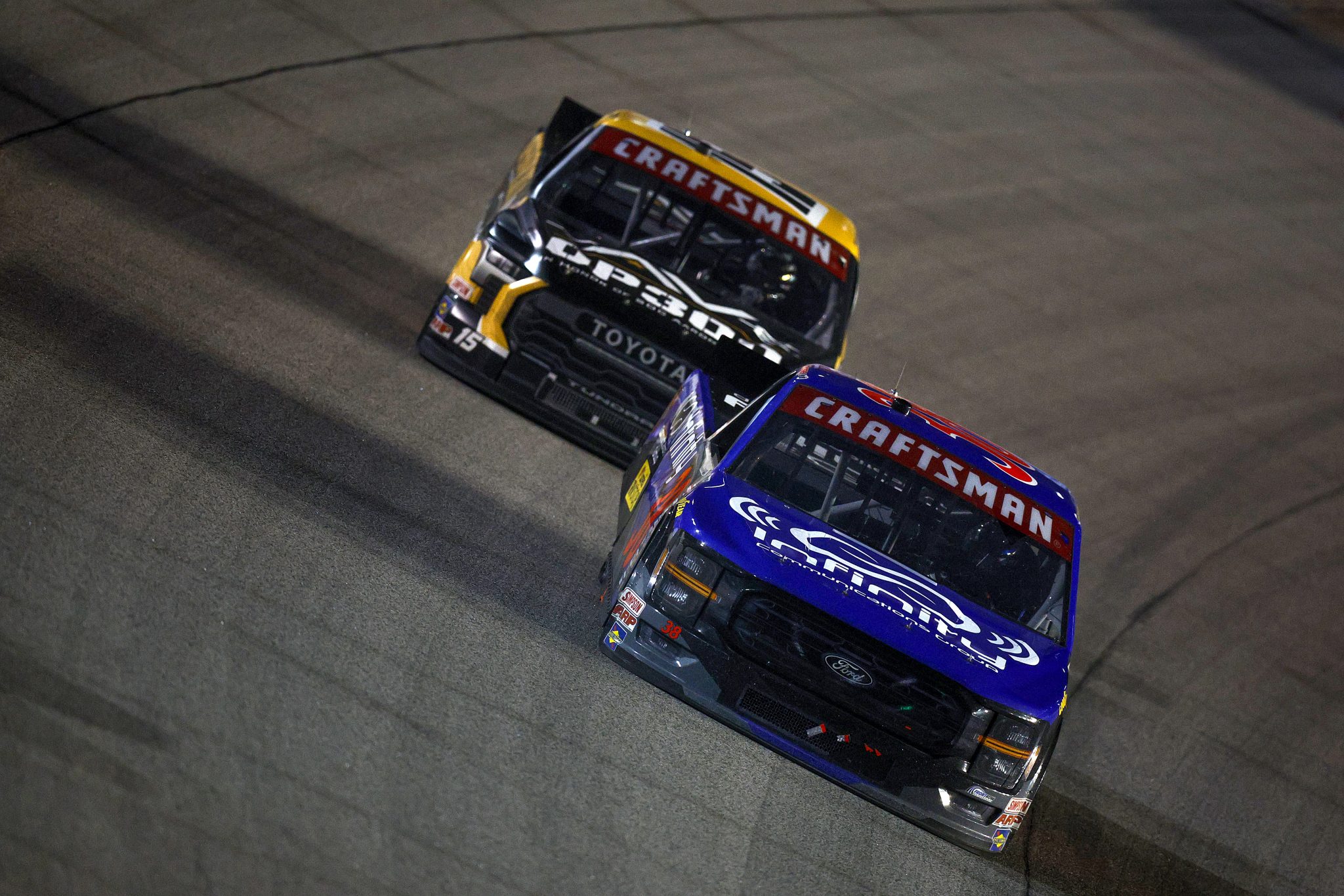 KANSAS CITY, KANSAS - SEPTEMBER 27: Layne Riggs, driver of the #38 Infinity Communications Group Ford, and Tanner Gray, driver of the #15 Operation 300 Toyota, race during the NASCAR Craftsman Truck Series Kubota Tractor 200 at Kansas Speedway on September 27, 2024 in Kansas City, Kansas. (Photo by Sean Gardner/Getty Images) | Getty Images