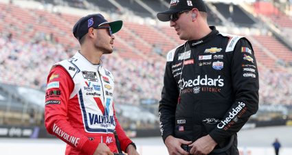 BRISTOL, TENNESSEE - SEPTEMBER 15: Kyle Larson, driver of the #5 Valvoline/Hendrickcars.com Chevrolet,(L) and Kyle Busch, driver of the #8 Cheddar's/ALSCO Uniforms Chevrolet, talk on the grid during qualifying for the NASCAR Cup Series Bass Pro Shops Night Race at Bristol Motor Speedway on September 15, 2023 in Bristol, Tennessee. (Photo by Meg Oliphant/Getty Images) | Getty Images