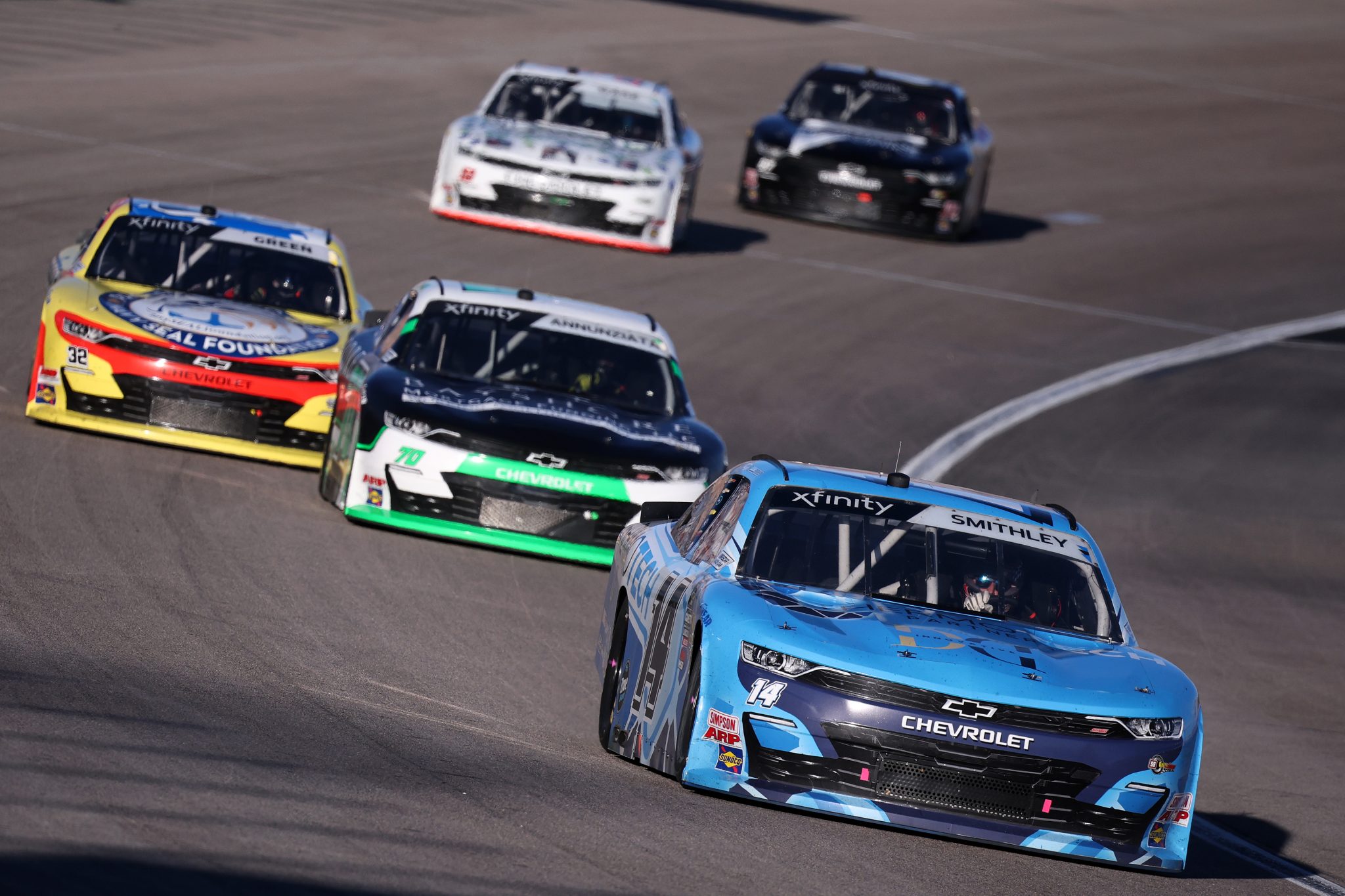 LAS VEGAS, NEVADA - OCTOBER 11: Garrett Smithley, driver of the #14 ThermoTech Chevrolet, Thomas Annunziata, driver of the #70 Bayshore Mortgage Chevrolet, and Austin Green, driver of the #32 3Dimensional.com Chevrolet, race during the NASCAR Xfinity SeriesFocused Health 302 at Las Vegas Motor Speedway on October 11, 2025 in Las Vegas, Nevada. (Photo by Chris Graythen/Getty Images) | Getty Images