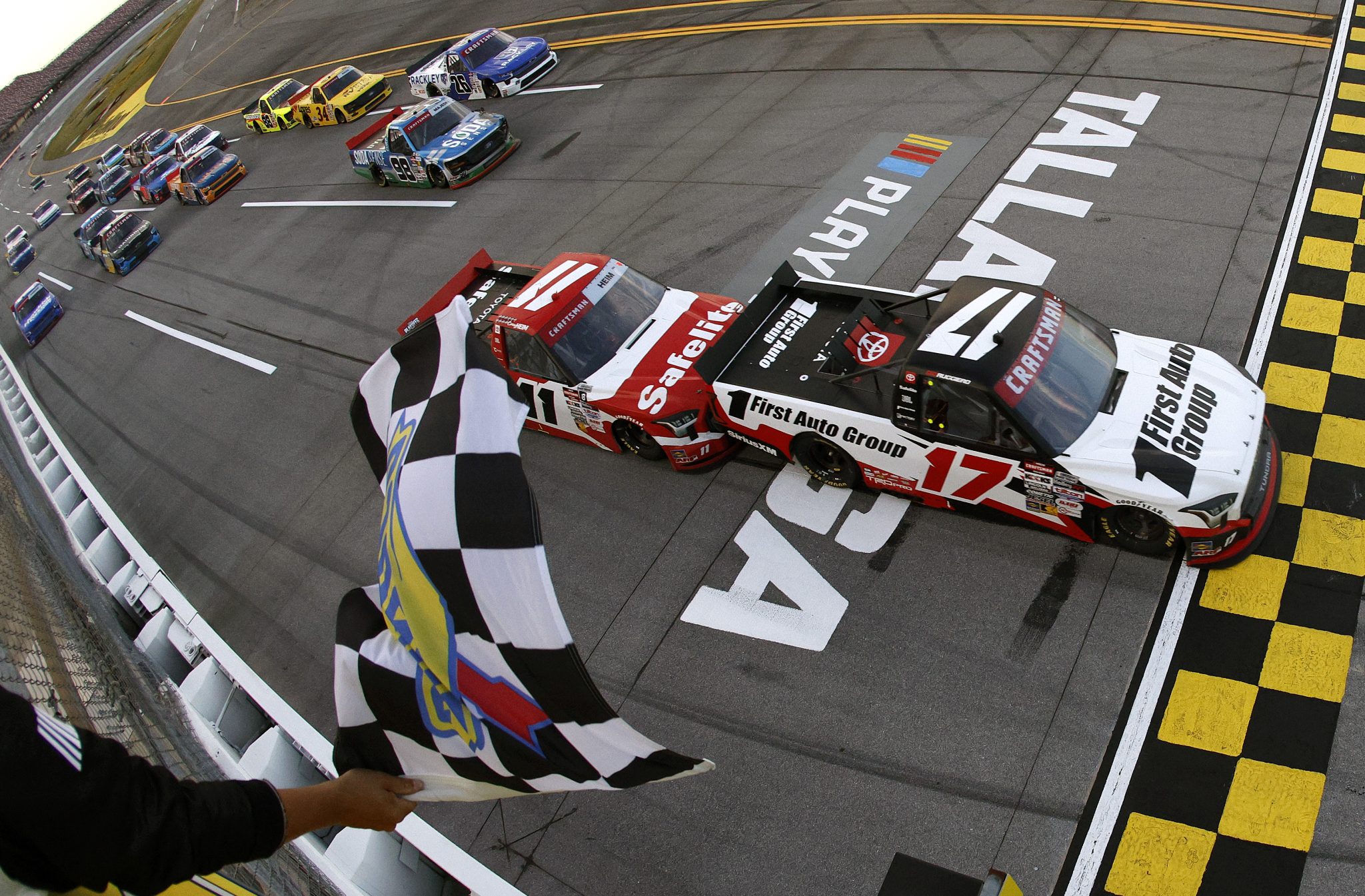 TALLADEGA, ALABAMA - OCTOBER 17: Giovanni Ruggiero, driver of the #17 First Auto Group Toyota, takes the checkered flag to win the NASCAR Craftsman Truck Series Love's RV Stop 225 at Talladega Superspeedway on October 17, 2025 in Talladega, Alabama. (Photo by Sean Gardner/Getty Images) | Getty Images