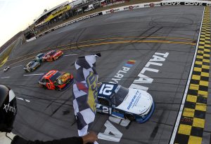 TALLADEGA, ALABAMA - OCTOBER 18: Austin Hill, driver of the #21 Bennett Transportation Chevrolet, takes the checkered flag to win the NASCAR Xfinity Series United Rentals 250 at Talladega Superspeedway on October 18, 2025 in Talladega, Alabama. (Photo by Sean Gardner/Getty Images) | Getty Images