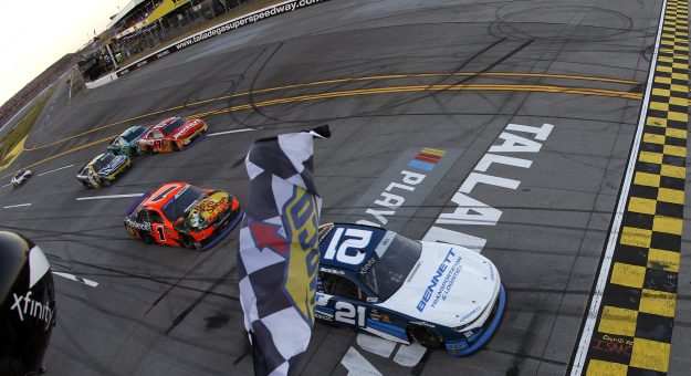 TALLADEGA, ALABAMA - OCTOBER 18: Austin Hill, driver of the #21 Bennett Transportation Chevrolet, takes the checkered flag to win the NASCAR Xfinity Series United Rentals 250 at Talladega Superspeedway on October 18, 2025 in Talladega, Alabama. (Photo by Sean Gardner/Getty Images) | Getty Images