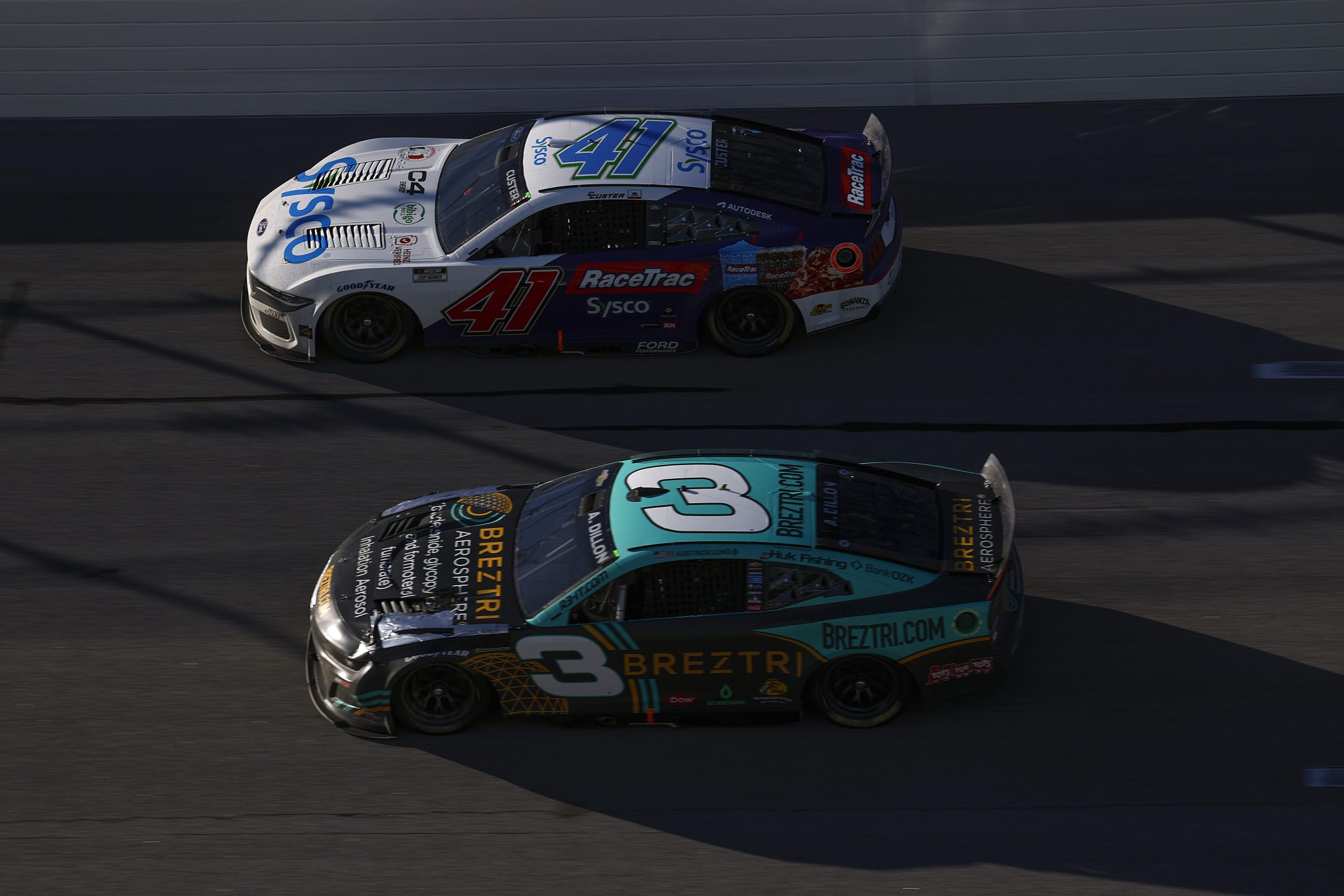TALLADEGA, ALABAMA - OCTOBER 19: Cole Custer, driver of the #41 Sysco RaceTrac Ford, and Austin Dillon, driver of the #3 Breztri Chevrolet, race during the NASCAR Cup Series YellaWood 500 at Talladega Superspeedway on October 19, 2025 in Talladega, Alabama. (Photo by Sean Gardner/Getty Images) | Getty Images