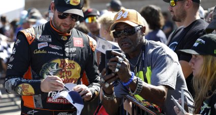 KANSAS CITY, KANSAS - SEPTEMBER 28: Chase Briscoe, driver of the #19 Bass Pro Shops Toyota, signs autographs for NASCAR fans on the grid prior to the NASCAR Cup Series Hollywood Casino 400 Presented by ESPN BET at Kansas Speedway on September 28, 2025 in Kansas City, Kansas. (Photo by Sean Gardner/Getty Images) | Getty Images