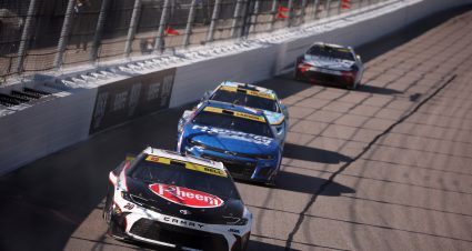 KANSAS CITY, KANSAS - SEPTEMBER 28: Christopher Bell, driver of the #20 Rheem Toyota, Kyle Larson, driver of the #5 HendrickCars.com Chevrolet, and Chase Elliott, driver of the #9 Kelley Blue Book Chevrolet, race during the NASCAR Cup Series Hollywood Casino 400 Presented by ESPN BET at Kansas Speedway on September 28, 2025 in Kansas City, Kansas. (Photo by Chris Graythen/Getty Images) | Getty Images