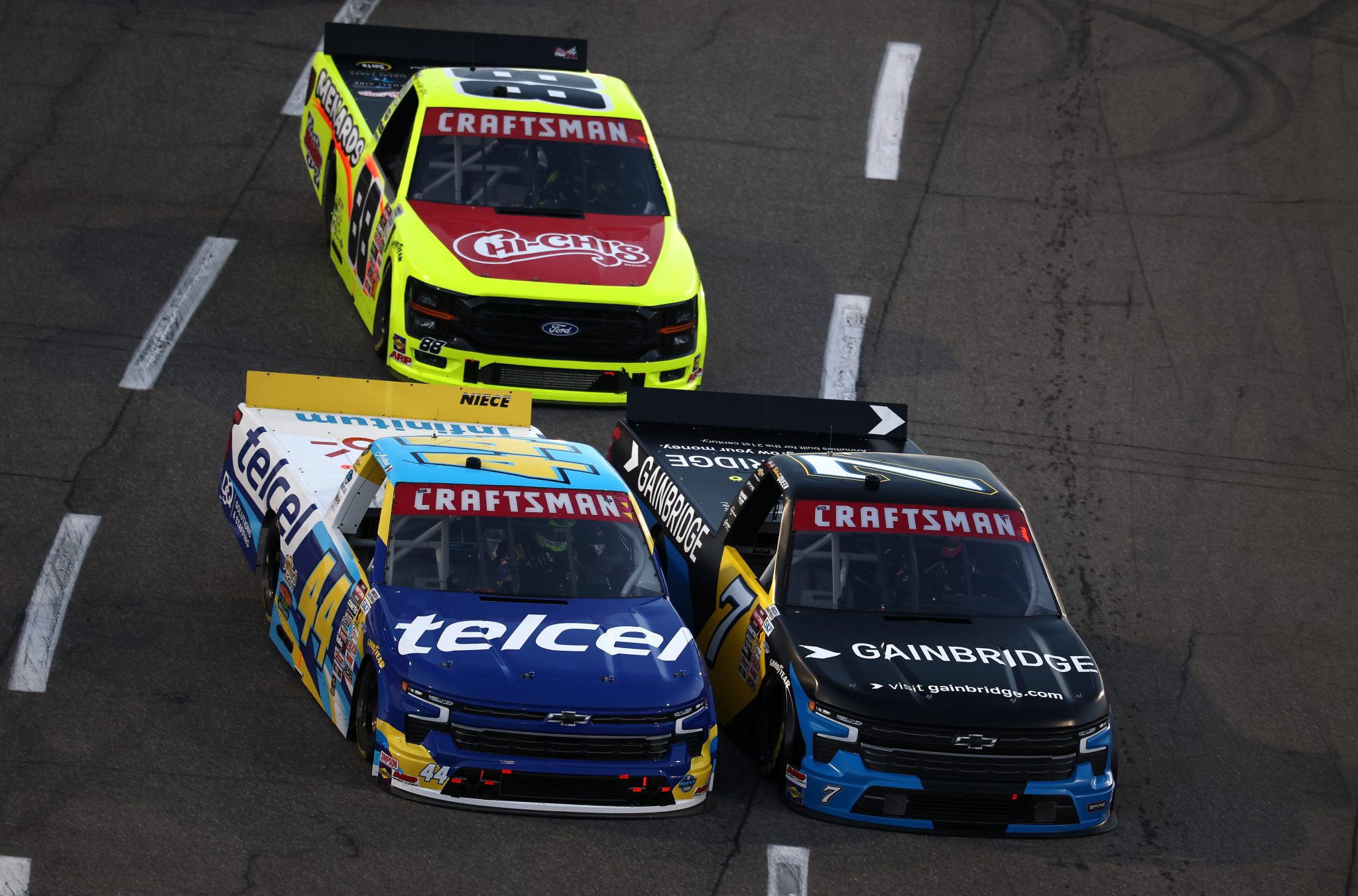 MARTINSVILLE, VIRGINIA - OCTOBER 24: Andres Perez De Lara, driver of the #44 Telcel Chevrolet, Brenden Queen, driver of the #7 Gainbridge Chevrolet, and Matt Crafton, driver of the #88 Chi Chis/Menards Ford, race during the NASCAR Craftsman Truck Slim Jim 200 at Martinsville Speedway on October 24, 2025 in Martinsville, Virginia. (Photo by Jared C. Tilton/Getty Images) | Getty Images