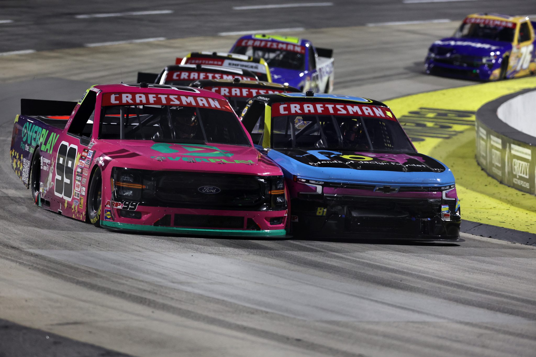 MARTINSVILLE, VIRGINIA - OCTOBER 24: Ben Rhodes, driver of the #99 OVERPLAY Ford, and Connor Mosack, driver of the #81 Friends of Jaclyn Foundation Chevrolet, race during the NASCAR Craftsman Truck Slim Jim 200 at Martinsville Speedway on October 24, 2025 in Martinsville, Virginia. (Photo by David Jensen/Getty Images) | Getty Images
