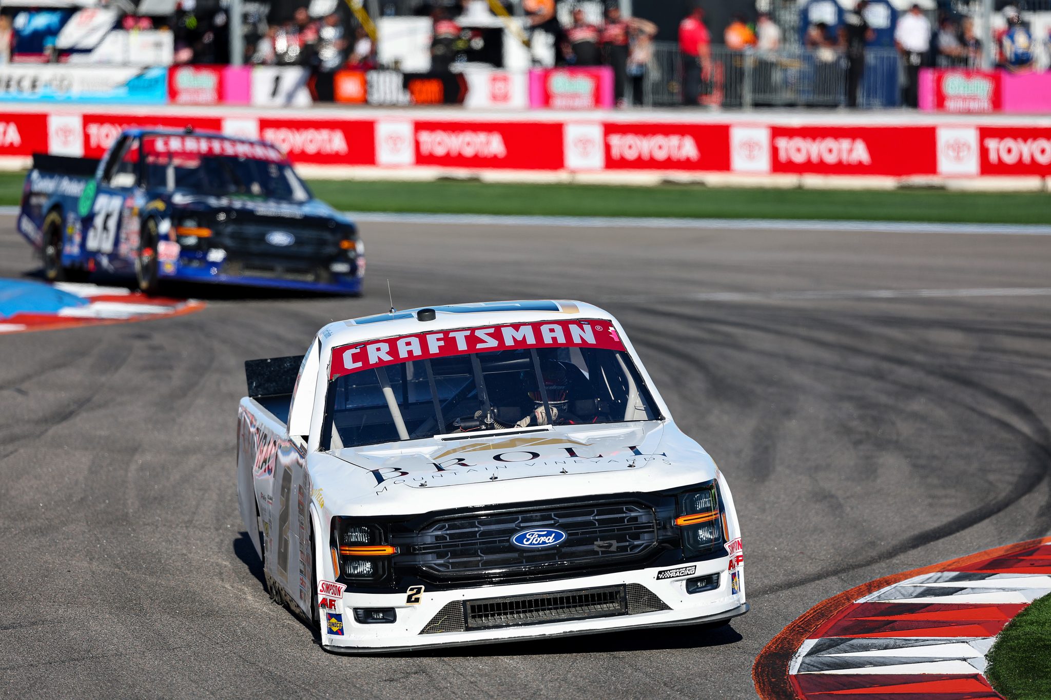andCONCORD, NORTH CAROLINA - OCTOBER 03: Carter Fartuch, driver of the #2 Broll Mountain Vineyards Ford, and Mason Maggio, driver of the #33 Control Alt Protect Ford, race during the NASCAR Craftsman Truck Series EcoSave 250 at Charlotte Motor Speedway on October 03, 2025 in Concord, North Carolina. (Photo by David Jensen/Getty Images) | Getty Images