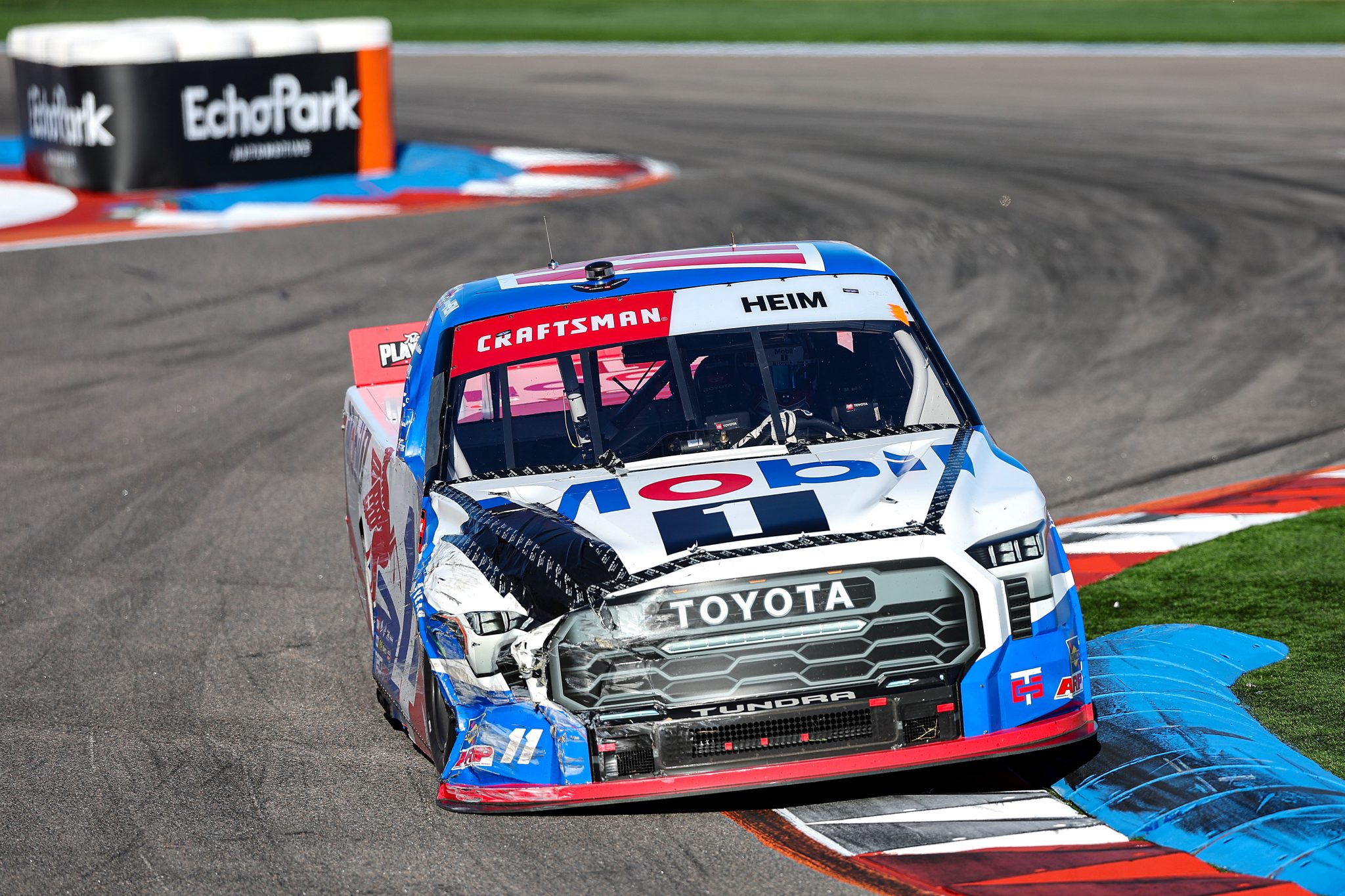 CONCORD, NORTH CAROLINA - OCTOBER 03: Corey Heim, driver of the #11 Mobil 1 Toyota, drives a damaged truck during the NASCAR Craftsman Truck Series EcoSave 250 at Charlotte Motor Speedway on October 03, 2025 in Concord, North Carolina. (Photo by David Jensen/Getty Images) | Getty Images