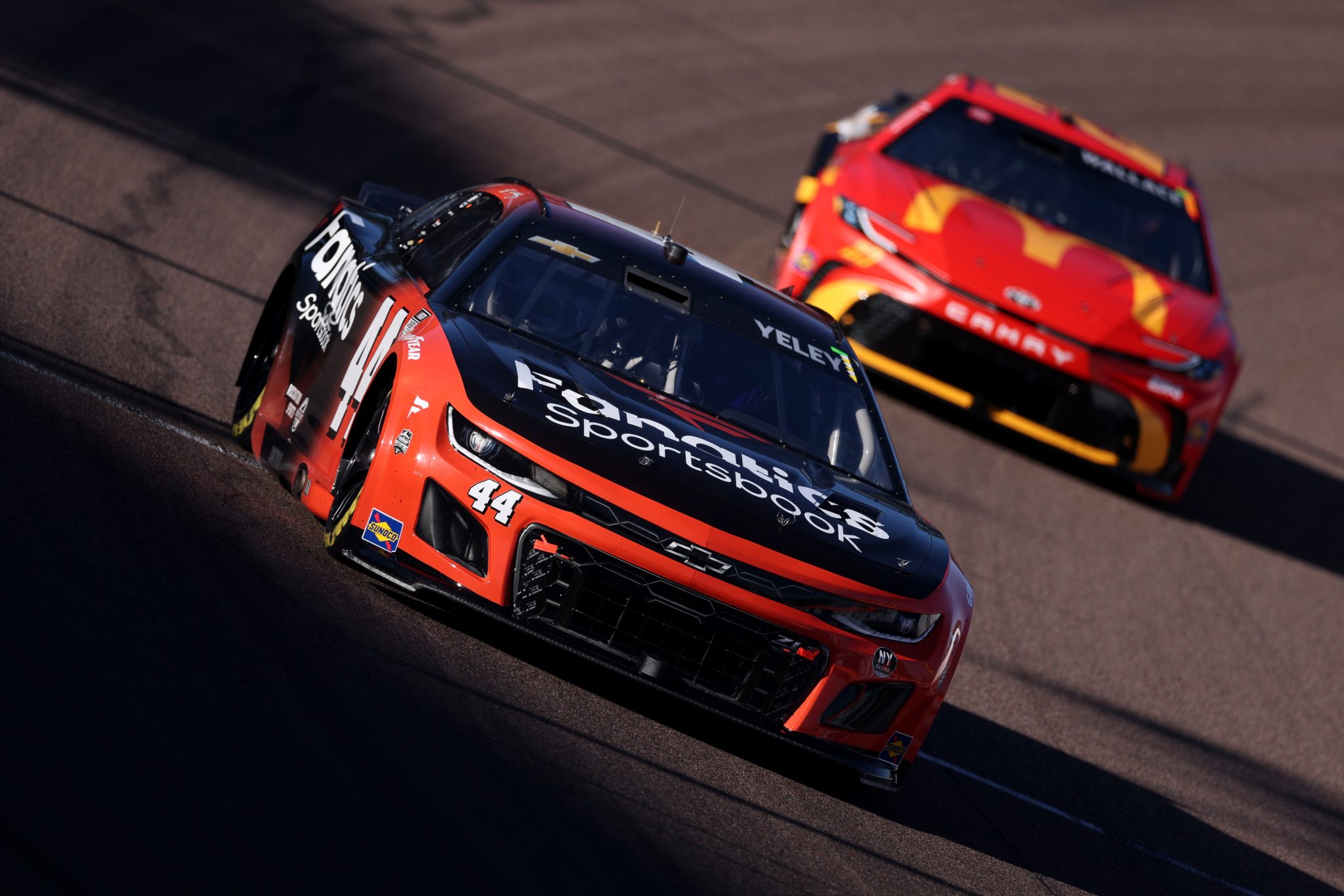 AVONDALE, ARIZONA - OCTOBER 31: JJ Yeley, driver of the #44 Fanatics Sportsbook Chevrolet, drives and Bubba Wallace, driver of the #23 McDonald's Toyota, drive during practice for the NASCAR Cup Series Championship at Phoenix Raceway on October 31, 2025 in Avondale, Arizona. (Photo by Christian Petersen/Getty Images) | Getty Images