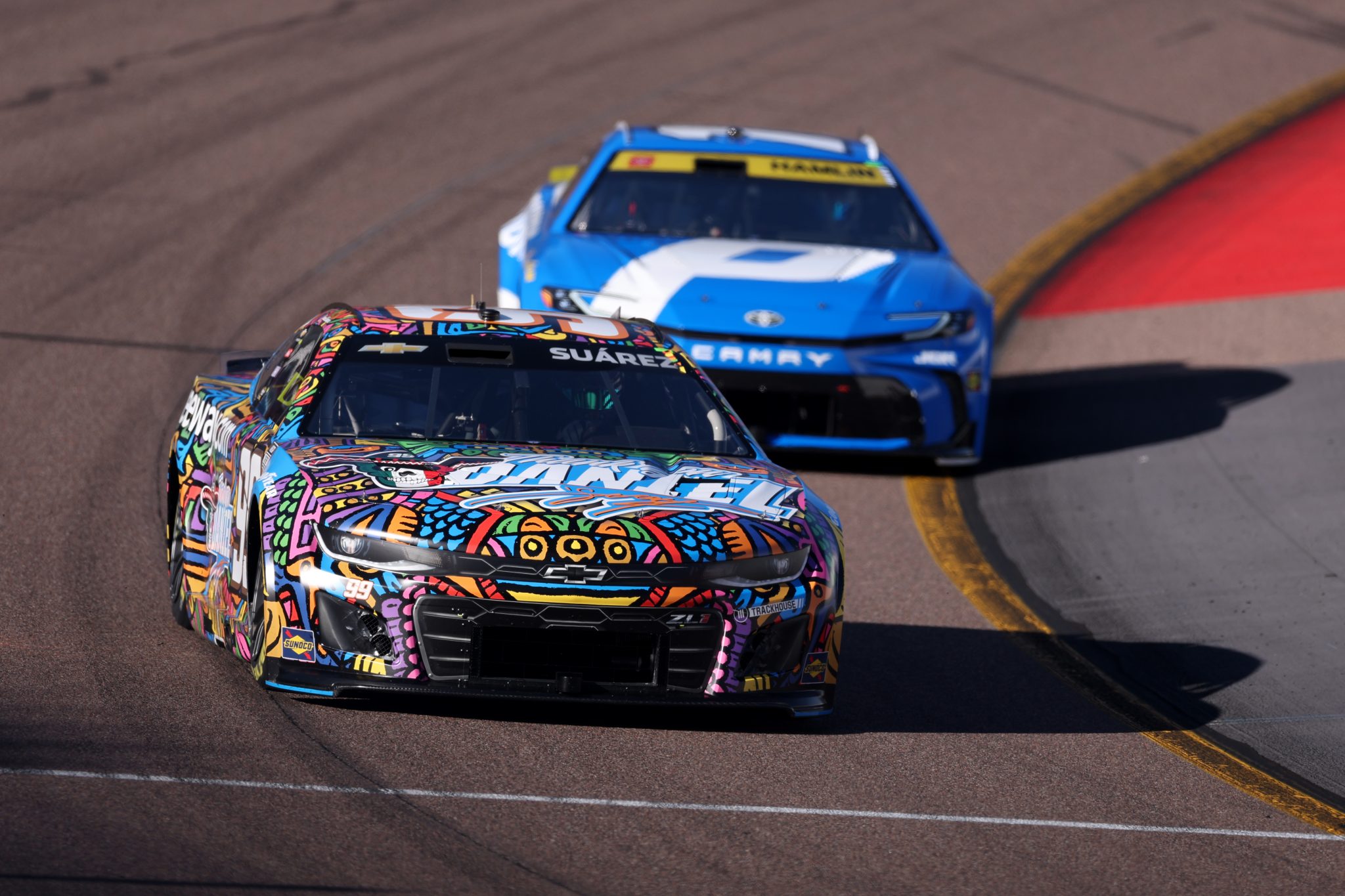 AVONDALE, ARIZONA - OCTOBER 31: Daniel Suarez, driver of the #99 Trackhouse Chevrolet, and Denny Hamlin, driver of the #11 Progressive Toyota, drive during practice for the NASCAR Cup Series Championship at Phoenix Raceway on October 31, 2025 in Avondale, Arizona. (Photo by Christian Petersen/Getty Images) | Getty Images