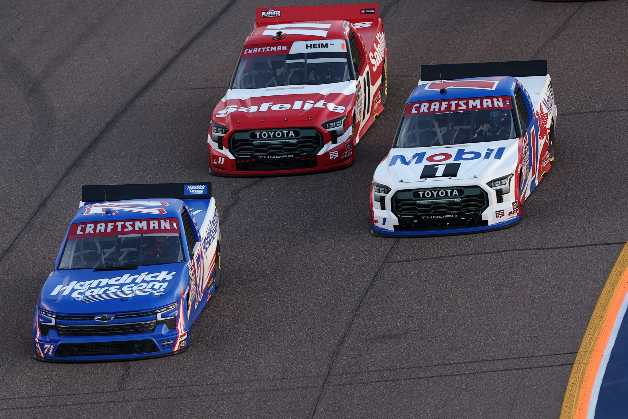 AVONDALE, ARIZONA - OCTOBER 31: Rajah Caruth, driver of the #71 HendrickCars.com Chevrolet, Corey Heim, driver of the #11 Safelite Toyota, and Brent Crews, driver of the #1 Mobil 1 Toyota, race during the NASCAR Craftsman Truck Series Championship at Phoenix Raceway on October 31, 2025 in Avondale, Arizona. (Photo by Christian Petersen/Getty Images) | Getty Images