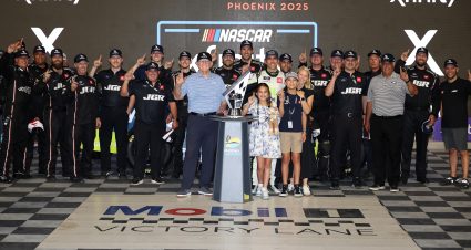 AVONDALE, ARIZONA - NOVEMBER 01: Aric Almirola, driver of the #19 Young Life Toyota, celebrates his wife, Janice Almirola, his son, Alex Almirola, daughter Abby Almirola and NASCAR Hall of Famer and  JGR team owner, Joe Gibbs,  after winning the NASCAR Xfinity Series Owner’s Championship after the NASCAR Xfinity Series Championship at Phoenix Raceway on November 01, 2025 in Avondale, Arizona. (Photo by James Gilbert/Getty Images) | Getty Images
