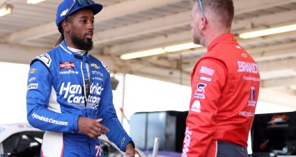 AVONDALE, ARIZONA - OCTOBER 31: NASCAR Craftsman Truck Series driver, Rajah Caruth (L) speaks to Justin Allgaier, driver of the #7 BRANDT Chevrolet, in the garage area during practice for the NASCAR Xfinity Series Championship at Phoenix Raceway on October 31, 2025 in Avondale, Arizona. (Photo by Meg Oliphant/Getty Images) | Getty Images