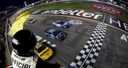 HAMPTON, GEORGIA - FEBRUARY 23: Christopher Bell, driver of the #20 DEWALT Toyota, takes the checkered flag under caution to win ahead of Carson Hocevar, driver of the #77 Delaware Life Chevrolet, and Kyle Larson, driver of the #5 HendirickCars.com Chevrolet, in the NASCAR Cup Series Ambetter Health 400 at Atlanta Motor Speedway on February 23, 2025 in Hampton, Georgia. (Photo by Chris Graythen/Getty Images) | Getty Images