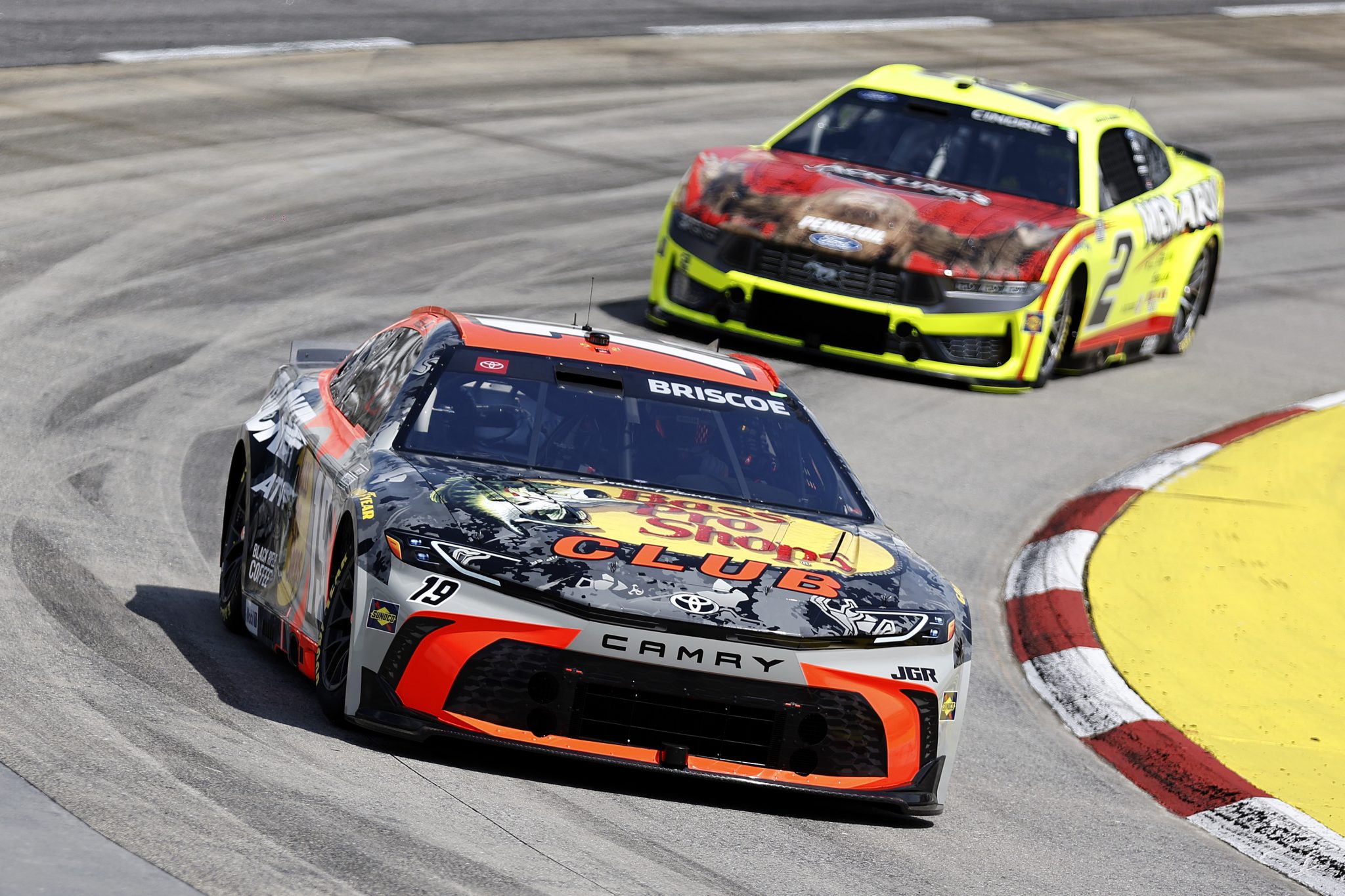 MARTINSVILLE, VIRGINIA - MARCH 29: Chase Briscoe, driver of the #19 Bass Pro Shops Toyota, and Austin Cindric, driver of the #2 Menards/Jack Links Ford, drive during practice for the NASCAR Cup Series Cook Out 400 at Martinsville Speedway on March 29, 2025 in Martinsville, Virginia. (Photo by Logan Riely/Getty Images) | Getty Images