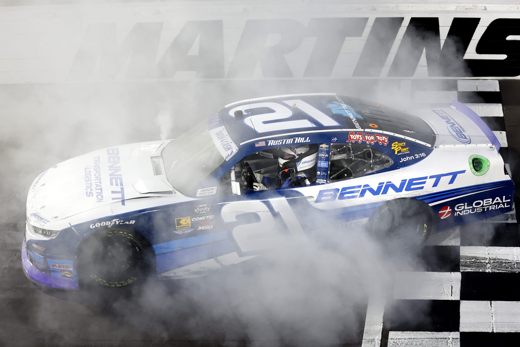MARTINSVILLE, VIRGINIA - MARCH 29: Austin Hill, driver of the #21 Bennett Transportation Chevrolet, celebrates with a burnout after winning the NASCAR Xfinity Series US Marine Corps 250 at Martinsville Speedway on March 29, 2025 in Martinsville, Virginia. (Photo by Logan Riely/Getty Images) | Getty Images