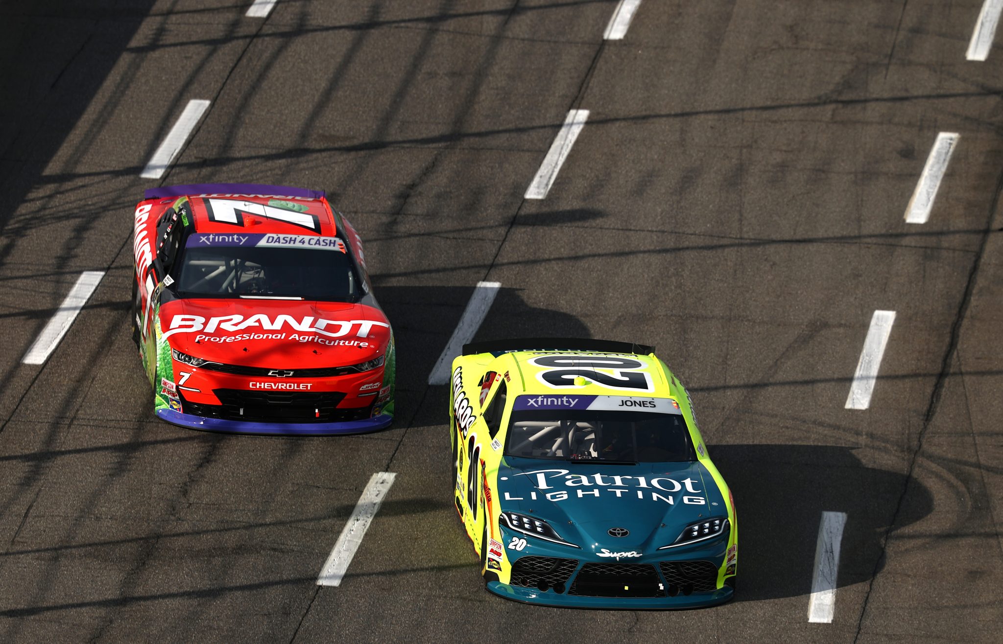 MARTINSVILLE, VIRGINIA - MARCH 29: Brandon Jones, driver of the #20 Menards/Patriot Lighting Toyota, and Justin Allgaier, driver of the #7 BRANDT Chevrolet, race during the NASCAR Xfinity Series US Marine Corps 250 at Martinsville Speedway on March 29, 2025 in Martinsville, Virginia. (Photo by Jared C. Tilton/Getty Images) | Getty Images