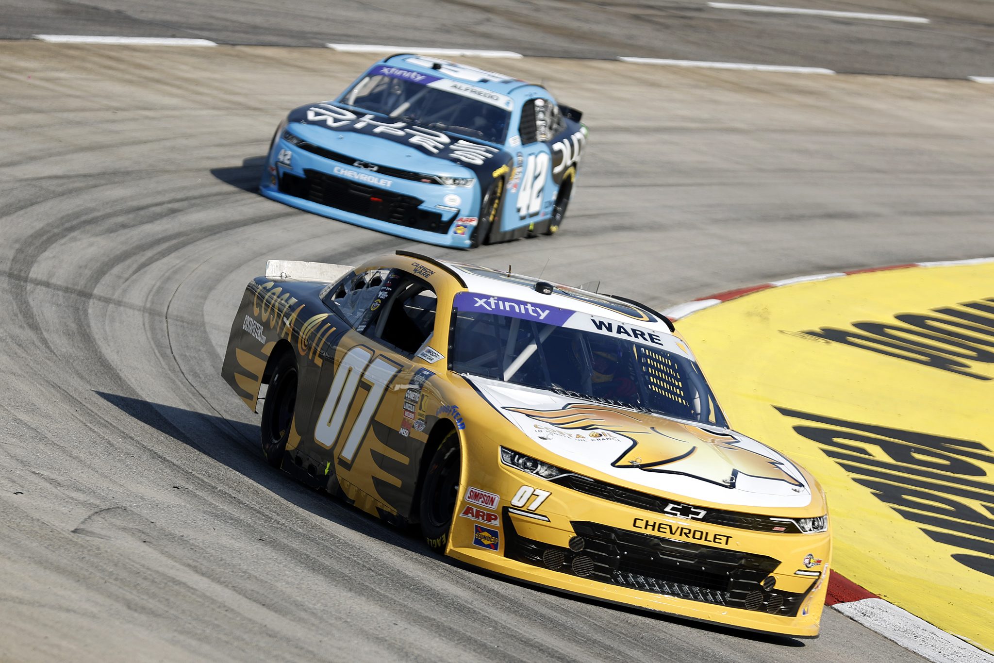MARTINSVILLE, VIRGINIA - MARCH 28: Carson Ware, driver of the #07 Costa Oil Chevrolet, and Anthony Alfredo, driver of the #42 Dude Wipes Chevrolet, drive during practice for the NASCAR Xfinity Series US Marine Corps 250 at Martinsville Speedway on March 28, 2025 in Martinsville, Virginia. (Photo by Logan Riely/Getty Images) | Getty Images