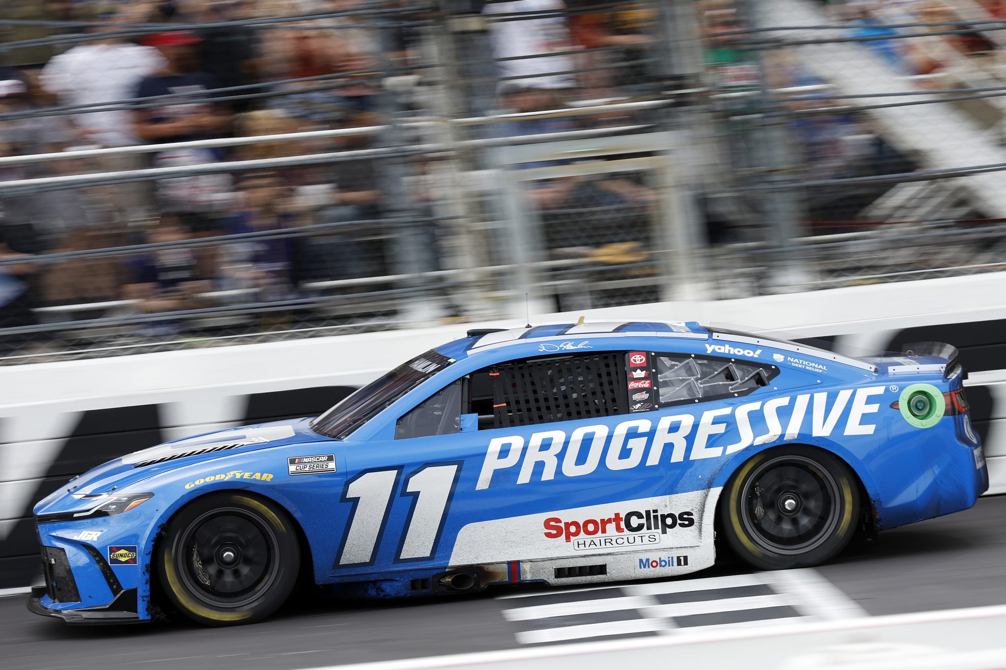 MARTINSVILLE, VIRGINIA - MARCH 30: Denny Hamlin, driver of the #11 Progressive Toyota, crosses the finish line to win the NASCAR Cup Series Cook Out 400 at Martinsville Speedway on March 30, 2025 in Martinsville, Virginia. (Photo by Logan Riely/Getty Images) | Getty Images