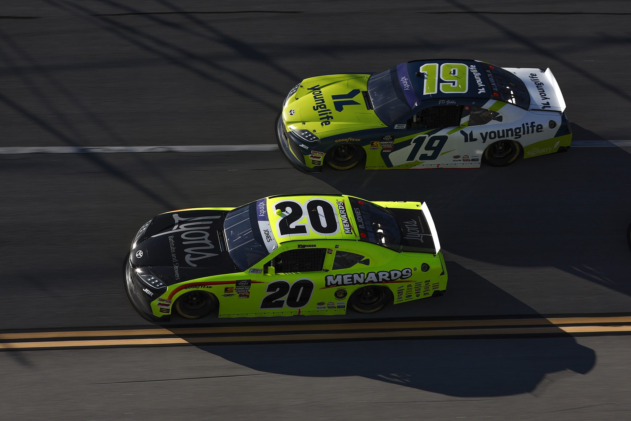 TALLADEGA, ALABAMA - APRIL 26: Brandon Jones, driver of the #20 Menards/Lyons Toyota, and Aric Almirola, driver of the #19 Young Life Toyota, race during the NASCAR Xfinity Series Ag-Pro 300 at Talladega Superspeedway on April 26, 2025 in Talladega, Alabama. (Photo by Sean Gardner/Getty Images) | Getty Images