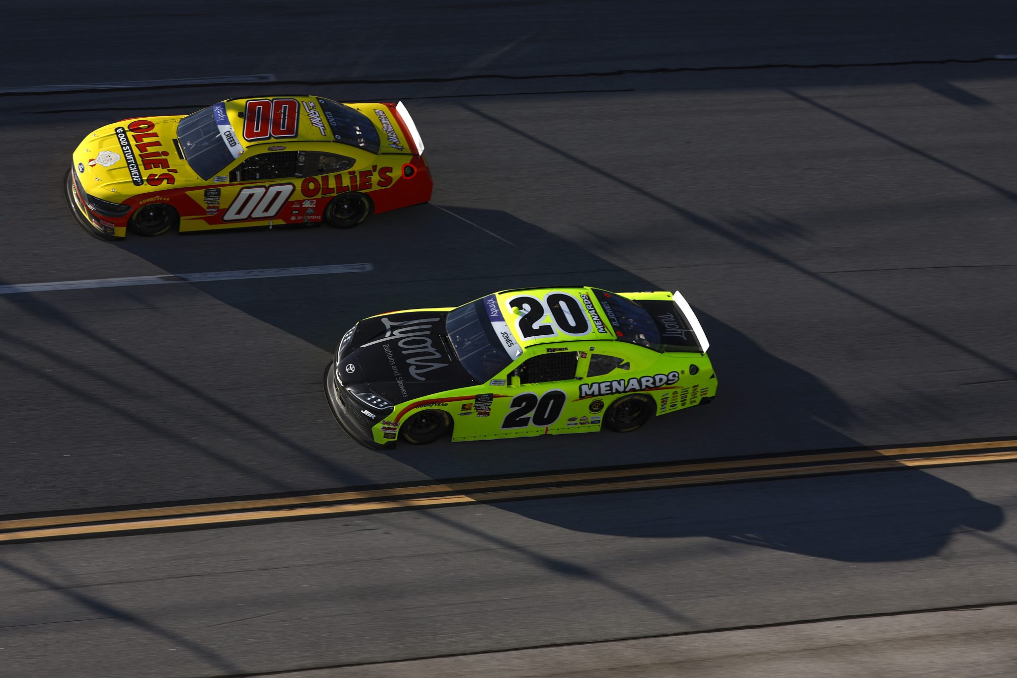 TALLADEGA, ALABAMA - APRIL 26: Brandon Jones, driver of the #20 Menards/Lyons Toyota, and Sheldon Creed, driver of the #00 Ollie's Ford, race during the NASCAR Xfinity Series Ag-Pro 300 at Talladega Superspeedway on April 26, 2025 in Talladega, Alabama. (Photo by Sean Gardner/Getty Images) | Getty Images