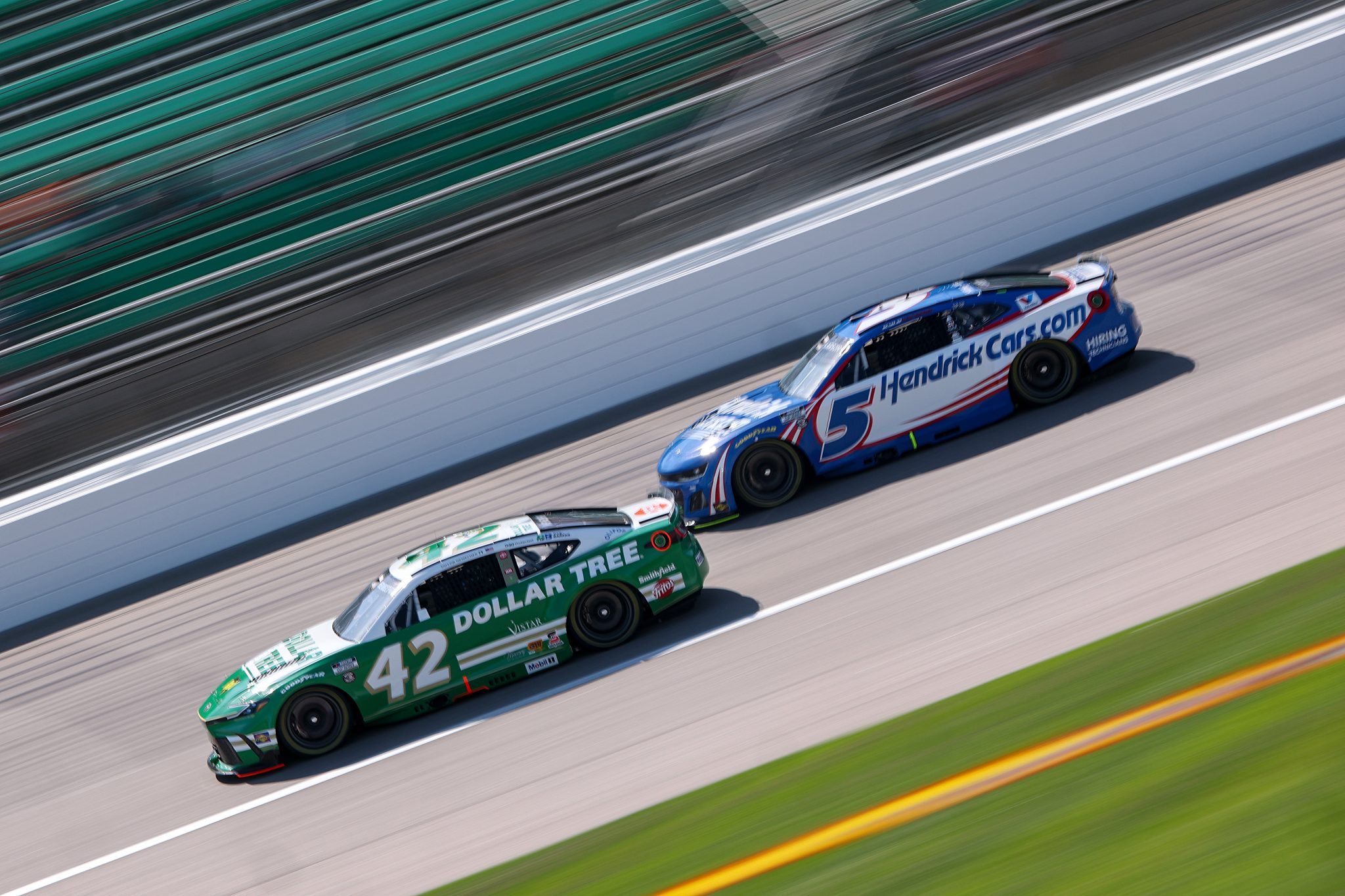 KANSAS CITY, KANSAS - MAY 10: John Hunter Nemechek, driver of the #42 Dollar Tree Toyota, and Kyle Larson, driver of the #5 HendrickCars.com Chevrolet, drive during practice for the NASCAR Cup Series AdventHealth 400 at Kansas Speedway on May 10, 2025 in Kansas City, Kansas. (Photo by Jamie Squire/Getty Images) | Getty Images
