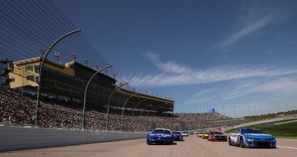 KANSAS CITY, KANSAS - MAY 11: Kyle Larson, driver of the #5 HendrickCars.com Chevrolet, and Chris Buescher, driver of the #17 Kroger/Kleenex Ford, lead the field on a pace lap prior to the NASCAR Cup Series AdventHealth 400 at Kansas Speedway on May 11, 2025 in Kansas City, Kansas. (Photo by Chris Graythen/Getty Images) | Getty Images