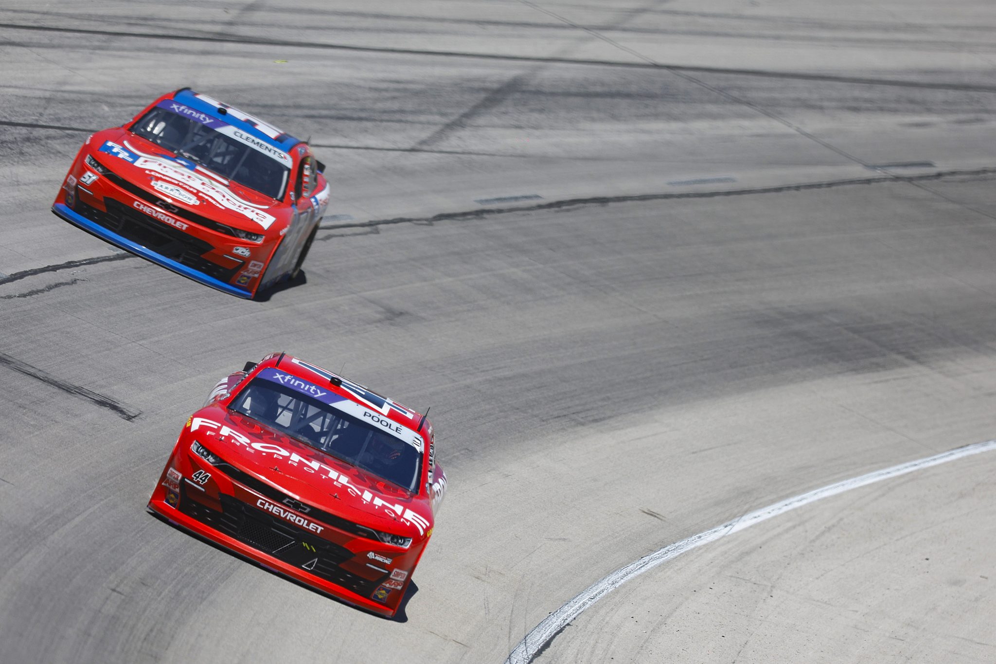 FORT WORTH, TEXAS - MAY 03: Brennan Poole, driver of the #44 Frontline Fire Protection Chevrolet, and Jeremy Clements, driver of the #51 First Pacific Funding Chevrolet, race during the NASCAR Xfinity Series Andy's Frozen Custard 300 at Texas Motor Speedway on May 03, 2025 in Fort Worth, Texas. (Photo by Logan Riely/Getty Images) | Getty Images