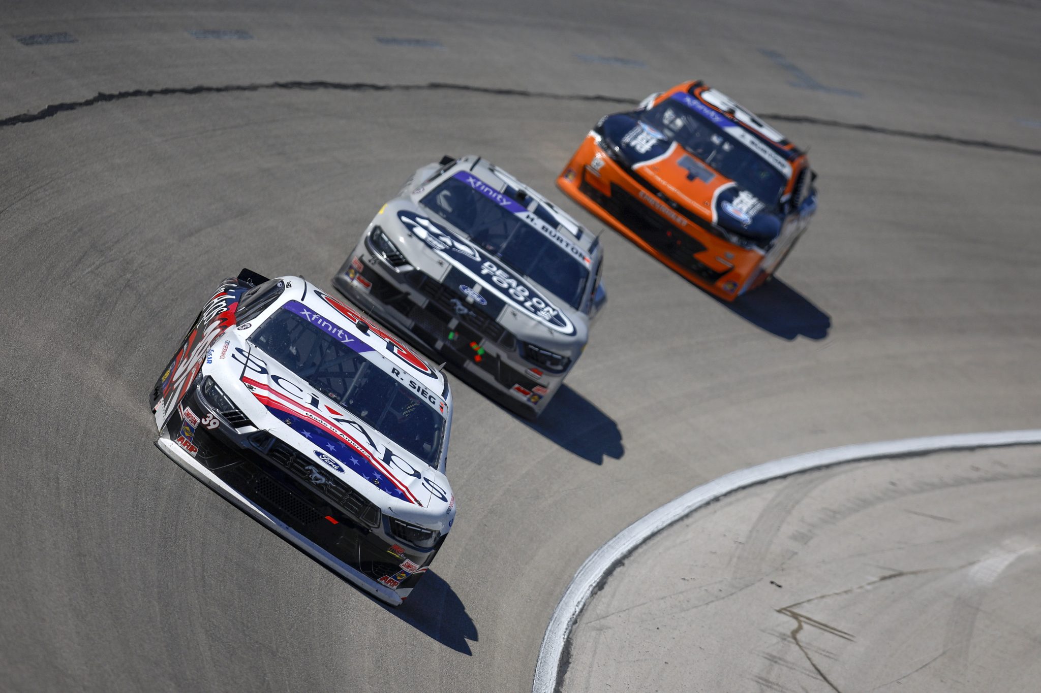 FORT WORTH, TEXAS - MAY 03: Ryan Sieg, driver of the #39 Sci Aps Ford, and Harrison Burton, driver of the #25 Dead On Tools Ford, race during the NASCAR Xfinity Series Andy's Frozen Custard 300 at Texas Motor Speedway on May 03, 2025 in Fort Worth, Texas. (Photo by Sean Gardner/Getty Images) | Getty Images