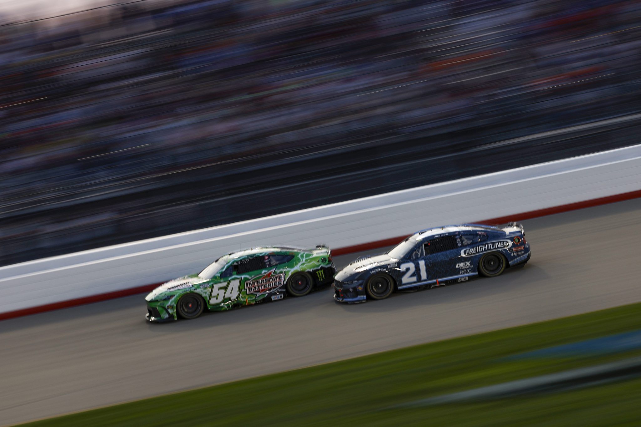 LEBANON, TENNESSEE - JUNE 01: Ty Gibbs, driver of the #54 Interstate Batteries Toyota, and Josh Berry, driver of the #21 Freightliner Ford, race during the NASCAR Cup Series Cracker Barrel 400 at Nashville Superspeedway on June 01, 2025 in Lebanon, Tennessee. (Photo by Sean Gardner/Getty Images) | Getty Images