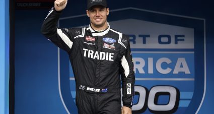 KANSAS CITY, KANSAS - MAY 04: Cam Waters, driver of the #66 TRADIE Ford, gives a thumbs up to fans as he walks onstage during driver intros prior to the NASCAR Craftsman Truck Series Heart of America 200 at Kansas Speedway on May 04, 2024 in Kansas City, Kansas. (Photo by Sean Gardner/Getty Images) | Getty Images