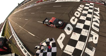 LONG POND, PENNSYLVANIA - JUNE 20: Layne Riggs, driver of the #34 Bare Knuckle Brawl Ford, takes the checkered flag to win the NASCAR Craftsman Truck Series MillerTech Battery 200 at Pocono Raceway on June 20, 2025 in Long Pond, Pennsylvania. (Photo by Jonathan Bachman/Getty Images) | Getty Images