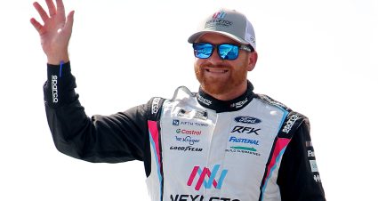 LONG POND, PENNSYLVANIA - JUNE 22: Chris Buescher, driver of the #17 Nexletol Ford, waves to fans as he walks onstage during driver intros prior to the NASCAR Cup Series The Great American Getaway 400 at Pocono Raceway on June 22, 2025 in Long Pond, Pennsylvania. (Photo by Jonathan Bachman/Getty Images) | Getty Images