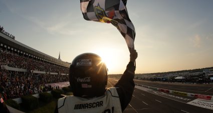LONG POND, PENNSYLVANIA - JUNE 22: A NASCAR Official waves the checkered flag during the NASCAR Cup Series The Great American Getaway 400 at Pocono Raceway on June 22, 2025 in Long Pond, Pennsylvania. (Photo by Jonathan Bachman/Getty Images) | Getty Images
