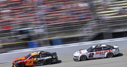 BROOKLYN, MICHIGAN - AUGUST 19: Bubba Wallace, driver of the #23 McDonald's Toyota, and Austin Cindric, driver of the #2 Discount Tire Ford, race during the NASCAR Cup Series FireKeepers Casino 400 at Michigan International Speedway on August 19, 2024 in Brooklyn, Michigan. (Photo by Logan Riely/Getty Images) | Getty Images