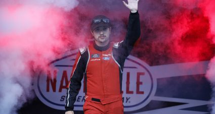 LEBANON, TENNESSEE - MAY 30: Tyler Tomassi, driver of the #22 Levrack Ford, waves to fans as he walks onstage during driver intros prior to the NASCAR Craftsman Truck Series Rackley Roofing 200 at Nashville Superspeedway on May 30, 2025 in Lebanon, Tennessee. (Photo by Sean Gardner/Getty Images) | Getty Images