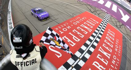 BROOKLYN, MICHIGAN - JUNE 08: Denny Hamlin, driver of the #11 Yahoo! Toyota, takes the checkered flag to win the NASCAR Cup Series FireKeepers Casino 400 at Michigan International Speedway on June 08, 2025 in Brooklyn, Michigan. (Photo by Chris Graythen/Getty Images) | Getty Images