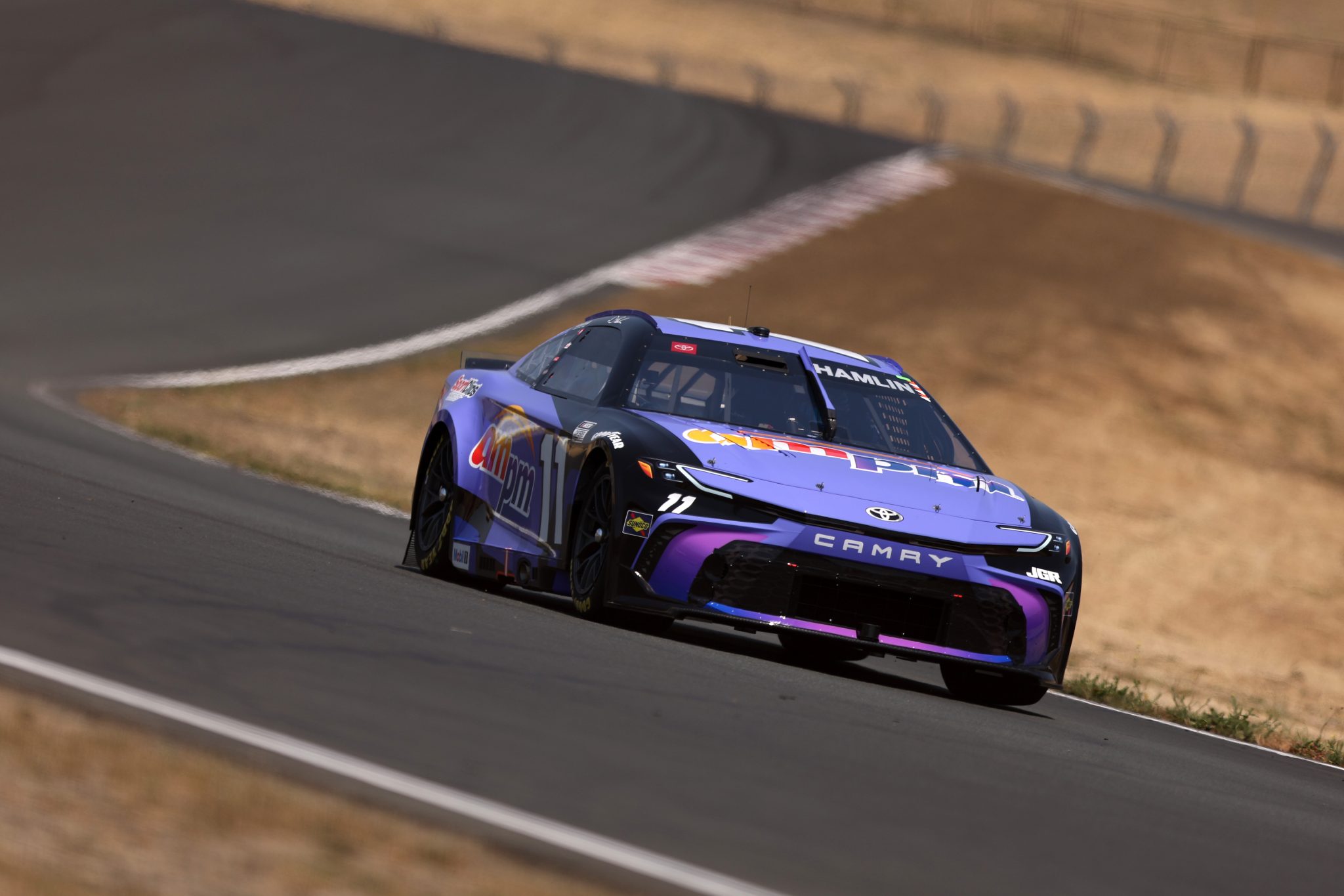 SONOMA, CALIFORNIA - JULY 12: Denny Hamlin, driver of the #11 ampm Toyota, drives during qualifying for the NASCAR Cup Series Toyota/Save Mart 350 at Sonoma Raceway on July 12, 2025 in Sonoma, California. (Photo by Meg Oliphant/Getty Images) | Getty Images