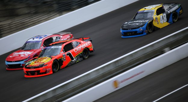 INDIANAPOLIS, INDIANA - JULY 26: Carson Kvapil, driver of the #1 Bass Pro Shops/Clarience Tech Chevrolet, David Starr, driver of the #35 Alarm Tech Systems Inc Chevrolet, and Nicholas Sanchez, driver of the #48 GainBridge Chevrolet, race during the NASCAR Xfinity Series Pennzoil 250 at Indianapolis Motor Speedway on July 26, 2025 in Indianapolis, Indiana. (Photo by Jonathan Bachman/Getty Images) | Getty Images