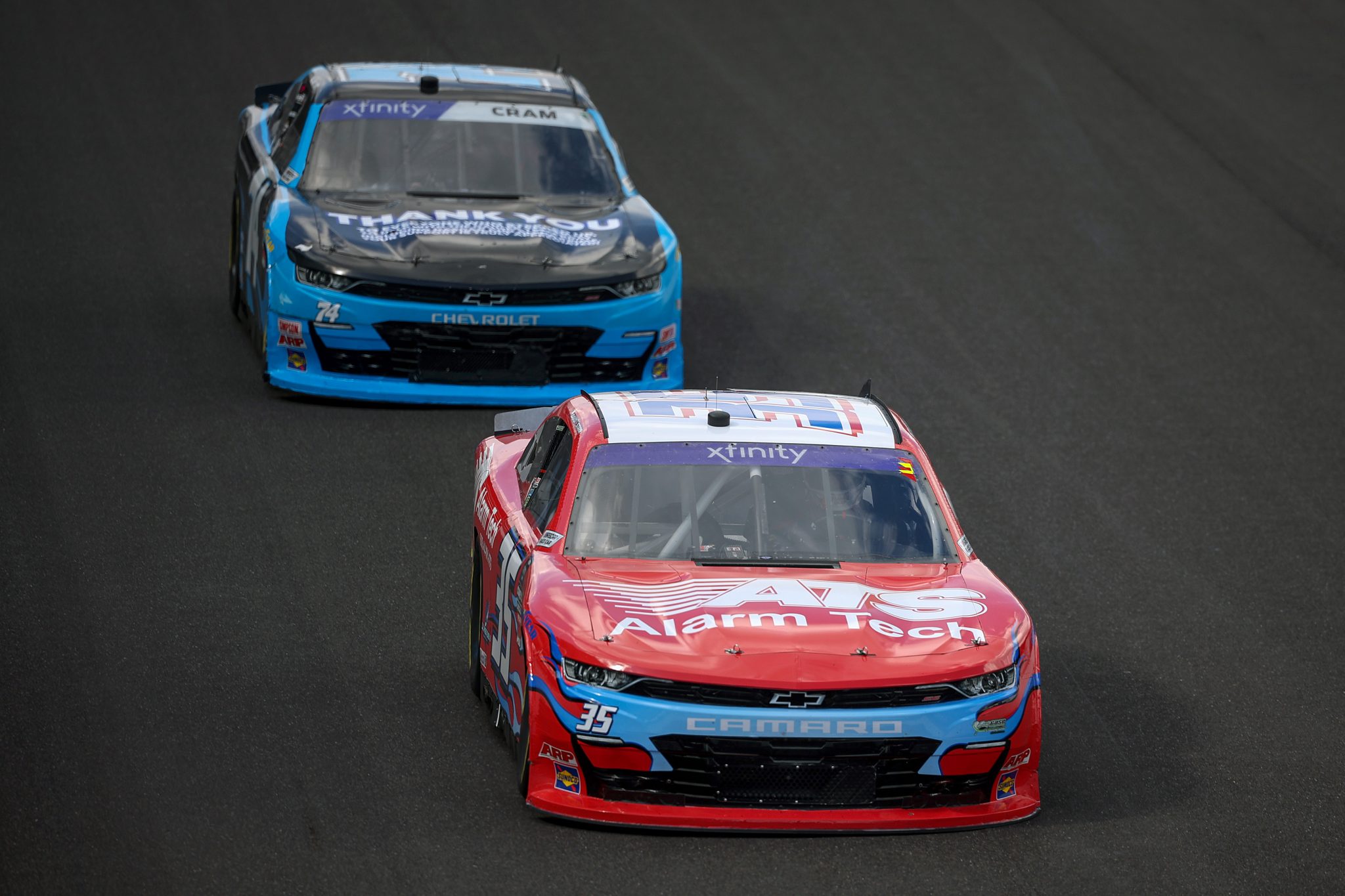 INDIANAPOLIS, INDIANA - JULY 26: David Starr, driver of the #35 Alarm Tech Systems Inc Chevrolet, and Dawson Cram, driver of the #74 Mike Harmon Racing Chevrolet, race during the NASCAR Xfinity Series Pennzoil 250 at Indianapolis Motor Speedway on July 26, 2025 in Indianapolis, Indiana. (Photo by James Gilbert/Getty Images) | Getty Images