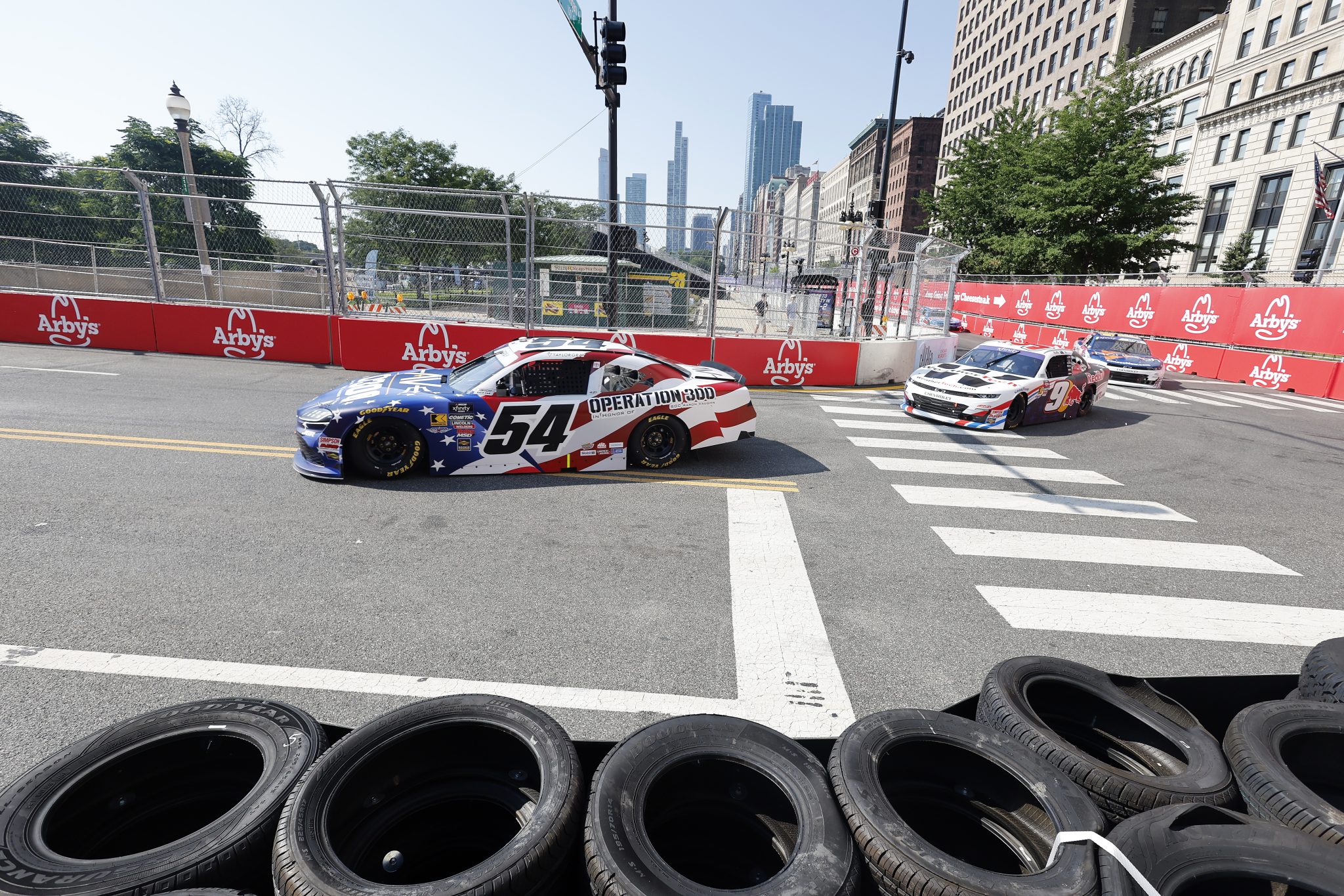 CHICAGO, ILLINOIS - JULY 05: Taylor Gray, driver of the #54 Operation 300 Toyota, and Shane Van Gisbergen, driver of the #9 WeatherTech/Red Bull Chevrolet, drive during practice for the NASCAR Xfinity Series The Loop 110 at Chicago Street Course on July 05, 2025 in Chicago, Illinois. (Photo by Logan Riely/Getty Images) | Getty Images