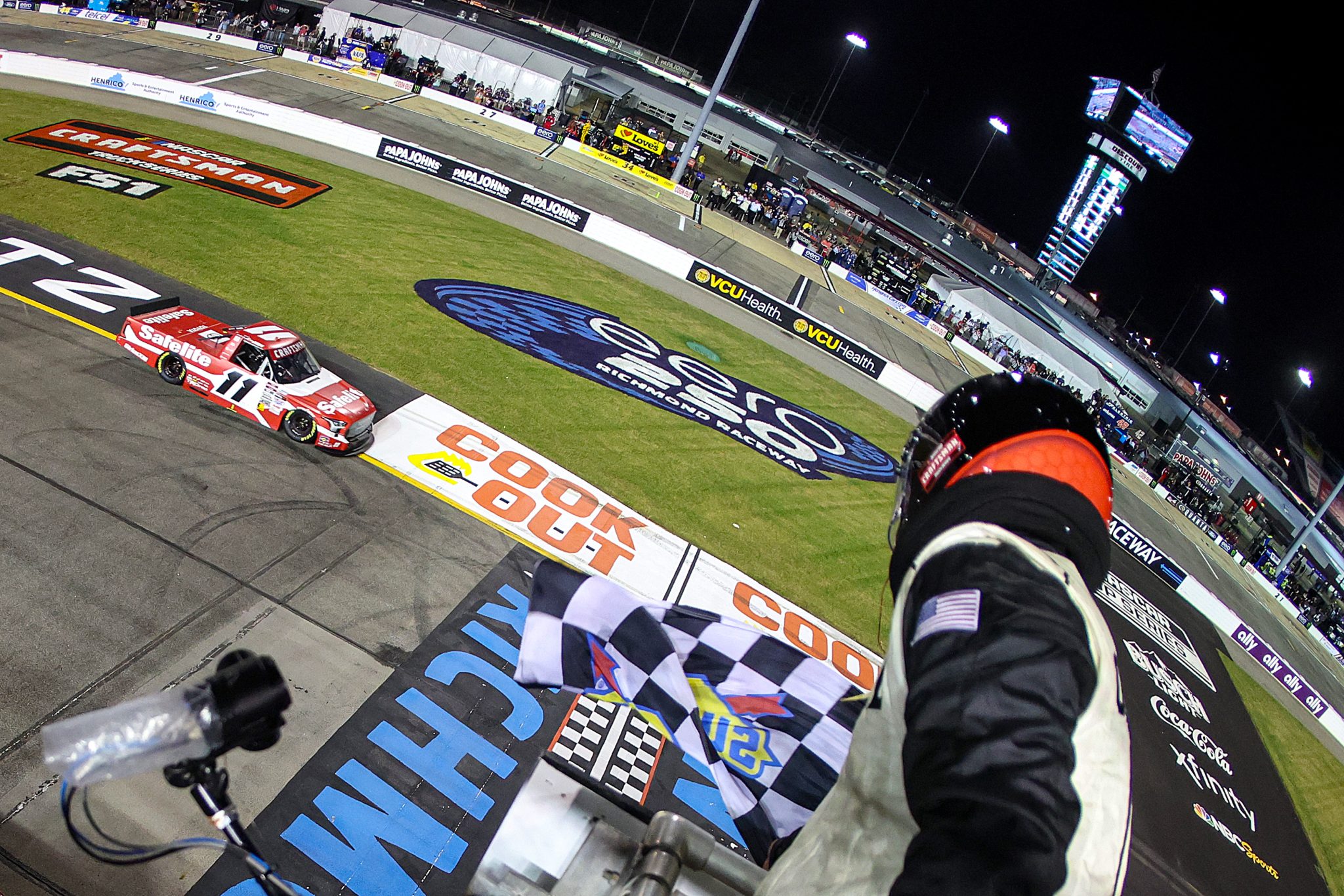 RICHMOND, VIRGINIA - AUGUST 15: Corey Heim, driver of the #11 Safelite Toyota, takes the checkered flag to win the NASCAR Craftsman Truck Series eero 250 at Richmond Raceway on August 15, 2025 in Richmond, Virginia. (Photo by Chris Graythen/Getty Images) | Getty Images