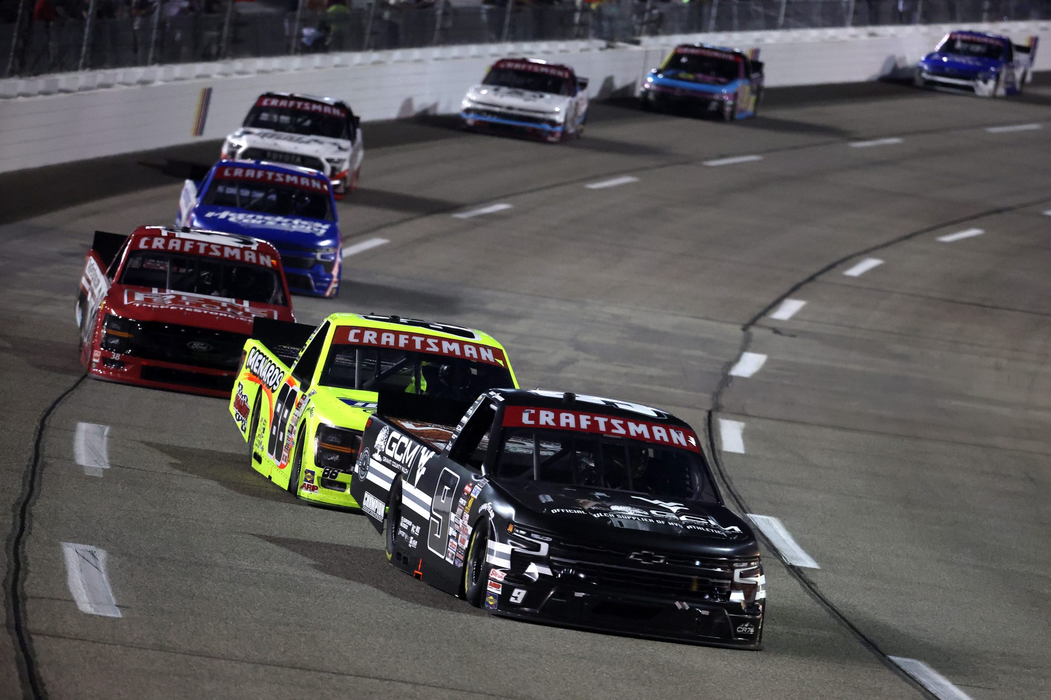 RICHMOND, VIRGINIA - AUGUST 15: Grant Enfinger, driver of the #9 Grant County Mulch WVU Chevrolet, Matt Crafton, driver of the #88 Ideal Door/Menards Ford, and Chandler Smith, driver of the #38 The Pete Store Ford, race during the NASCAR Craftsman Truck Series eero 250 at Richmond Raceway on August 15, 2025 in Richmond, Virginia. (Photo by Chris Graythen/Getty Images) | Getty Images
