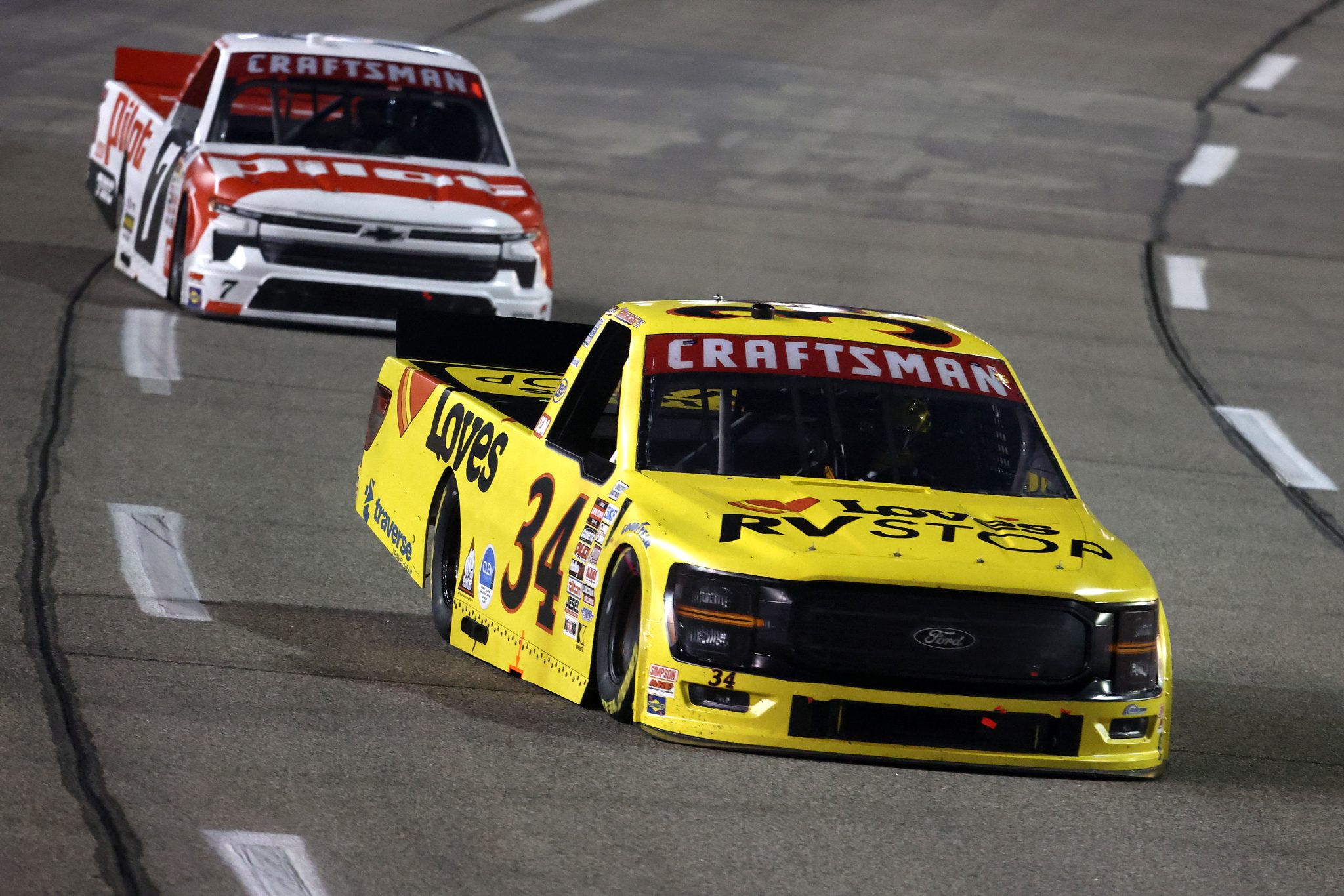 RICHMOND, VIRGINIA - AUGUST 15: Layne Riggs, driver of the #34 Love's RV STOP Ford, and Sammy Smith, driver of the #7 Pilot Chevrolet, race during the NASCAR Craftsman Truck Series eero 250 at Richmond Raceway on August 15, 2025 in Richmond, Virginia. (Photo by Chris Graythen/Getty Images) | Getty Images