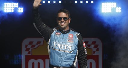 WATKINS GLEN, NEW YORK - AUGUST 08: Timmy Hill, driver of the #56 UNITS Storage Toyota, waves to fans as he walks onstage during driver intros prior to the NASCAR Craftsman Truck Series Mission 176 at The Glen at Watkins Glen International on August 08, 2025 in Watkins Glen, New York. (Photo by Sean Gardner/Getty Images) | Getty Images