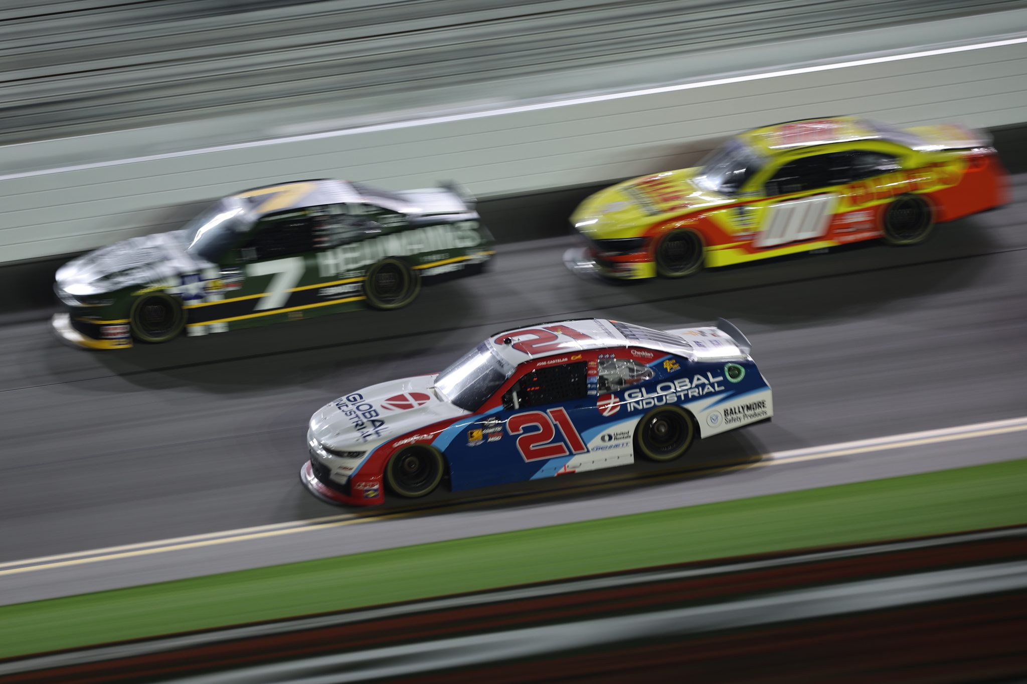 DAYTONA BEACH, FLORIDA - AUGUST 22: Austin Hill, driver of the #21 Global Industrial Chevrolet, races Justin Allgaier, driver of the #7 Hellmann's/RCPT Chevrolet, and Sheldon Creed, driver of the #00 Ollie's Ford, during the NASCAR Xfinity Series Wawa 250 Powered By Coca-Cola at Daytona International Speedway on August 22, 2025 in Daytona Beach, Florida. (Photo by James Gilbert/Getty Images) | Getty Images