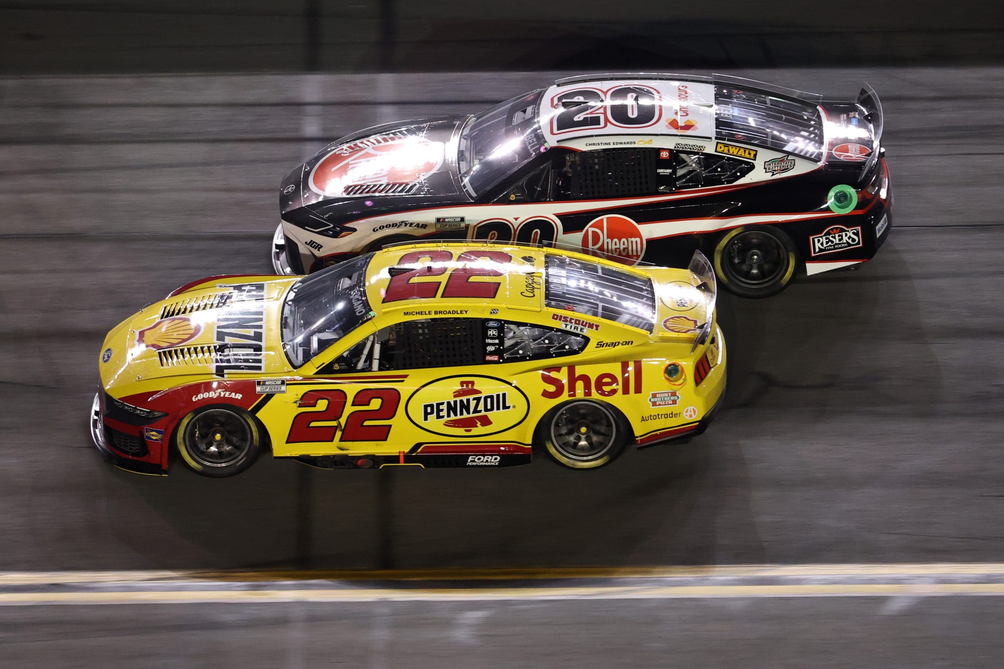 DAYTONA BEACH, FLORIDA - AUGUST 23: Joey Logano, driver of the #22 Shell Pennzoil Ford, races Christopher Bell, driver of the #20 Rheem Toyota, during the NASCAR Cup Series Coke Zero Sugar 400 at Daytona International Speedway on August 23, 2025 in Daytona Beach, Florida. (Photo by Chris Graythen/Getty Images) | Getty Images