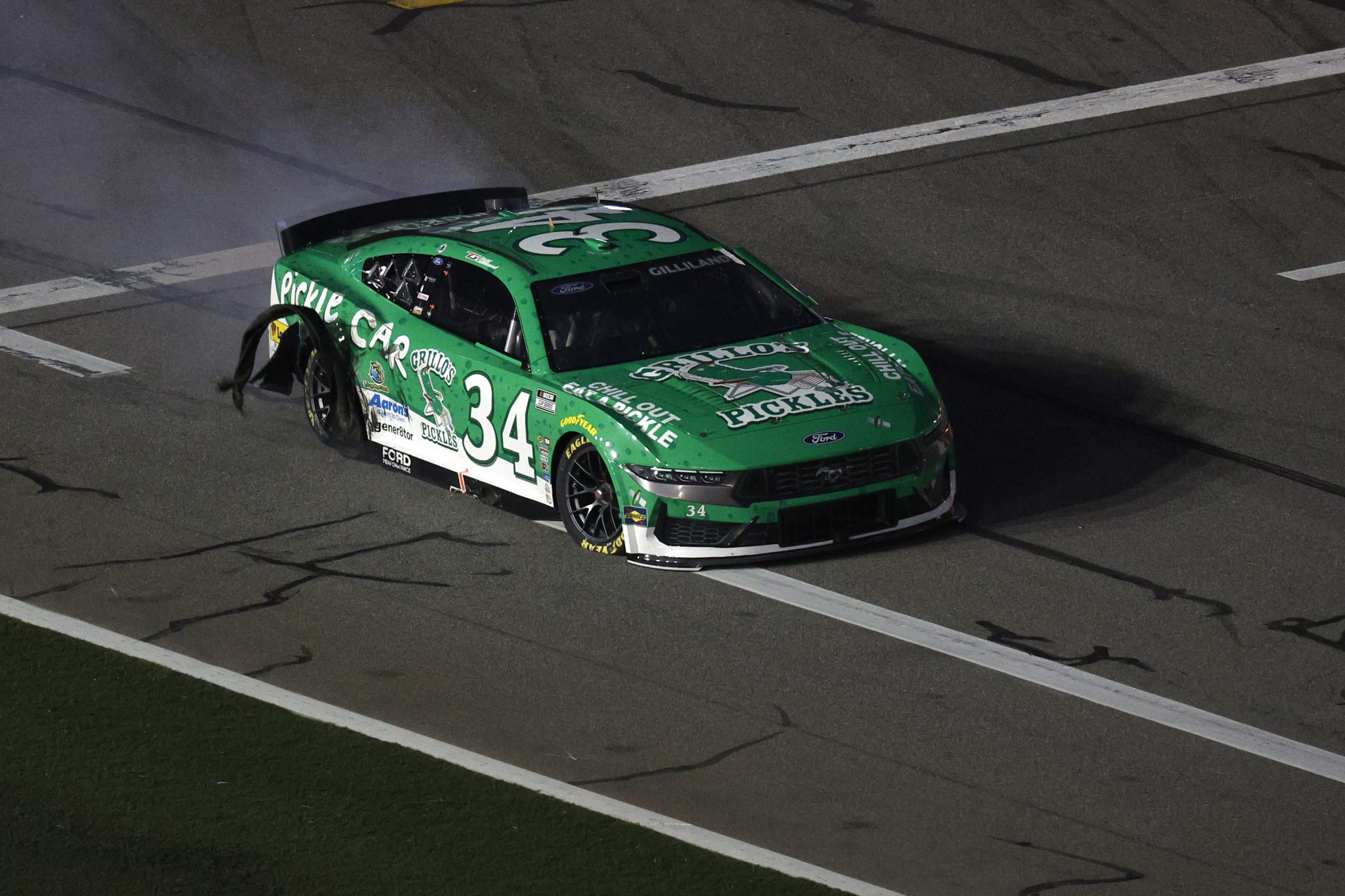 DAYTONA BEACH, FLORIDA - AUGUST 23: Todd Gilliland, driver of the #34 Grillo's Pickles Ford, drives on pit road with damage after an incident during the NASCAR Cup Series Coke Zero Sugar 400 at Daytona International Speedway on August 23, 2025 in Daytona Beach, Florida. (Photo by Sean Gardner/Getty Images) | Getty Images