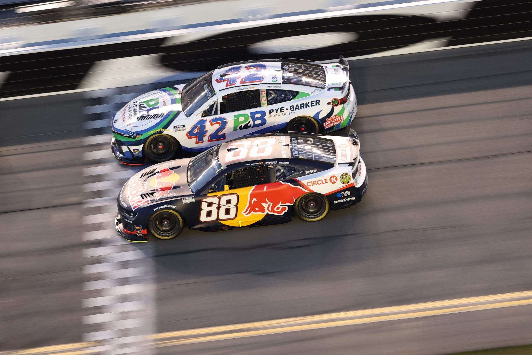 DAYTONA BEACH, FLORIDA - AUGUST 23: Shane Van Gisbergen, driver of the #88 Red Bull Chevrolet, and John H. Nemechek, driver of the #42 Pye Barker Fire & Safety Toyota, race during the NASCAR Cup Series Coke Zero Sugar 400 at Daytona International Speedway on August 23, 2025 in Daytona Beach, Florida. (Photo by Chris Graythen/Getty Images) | Getty Images